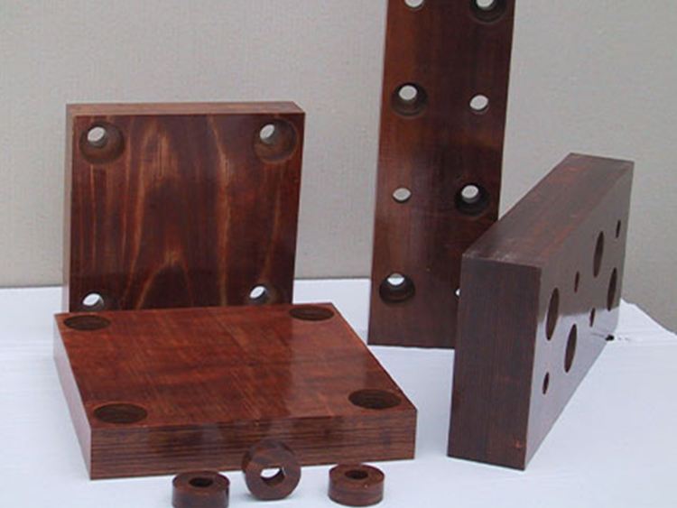 Electrical densified laminated wood for transformer clamping frames and end caps